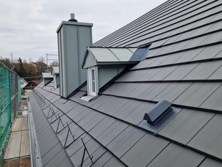 Dormer and chimney with metal flashings